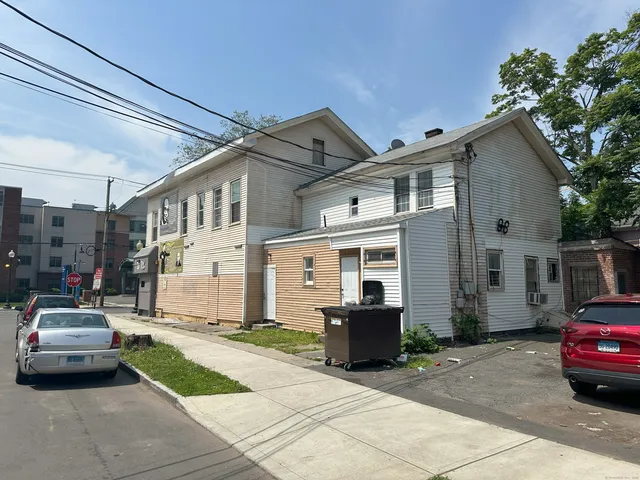 a car parked in front of white house