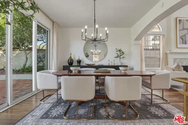 a view of a dining room with furniture wooden floor and a chandelier