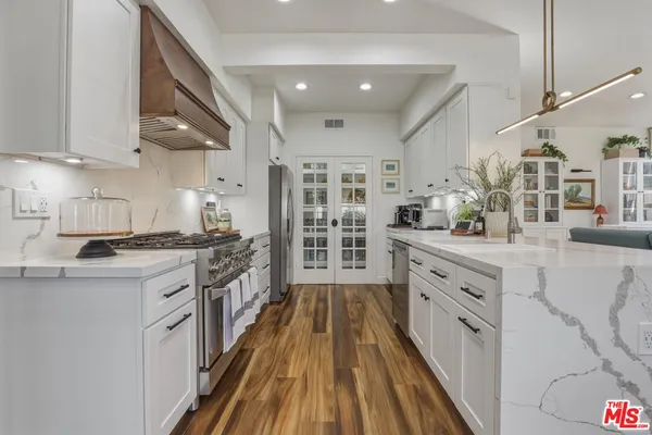 a kitchen with stainless steel appliances granite countertop lots of counter top space and cabinets