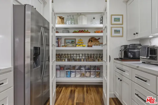 a kitchen with stainless steel appliances granite countertop a refrigerator and cabinets