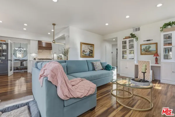 a living room with furniture and kitchen view