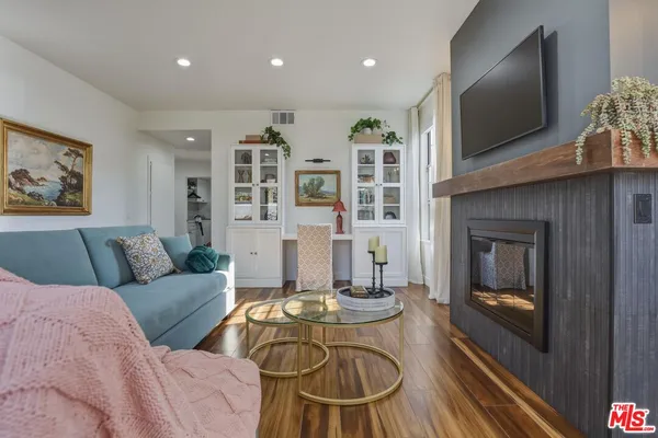 a living room with furniture fireplace and flat screen tv