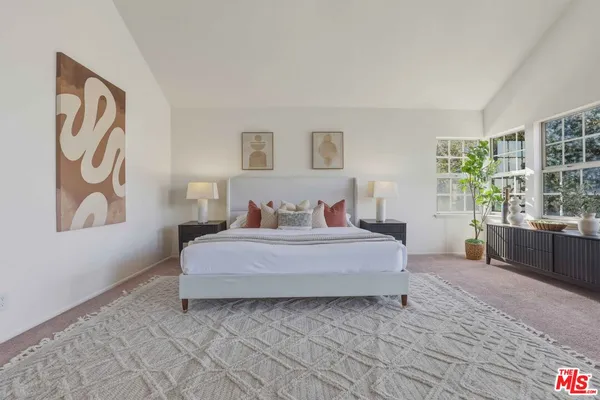 a spacious bedroom with a bed and a fireplace