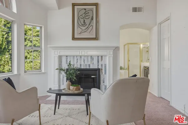 a large bathroom with a double vanity sink a large mirror and a bathtub