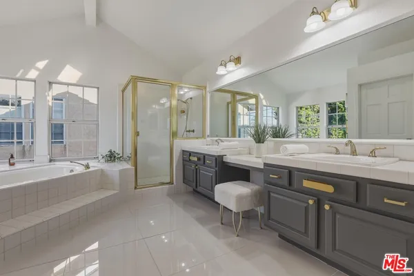 a spacious bathroom with a tub shower and a sink