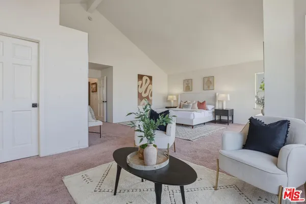 a bedroom with a bed and a mirror