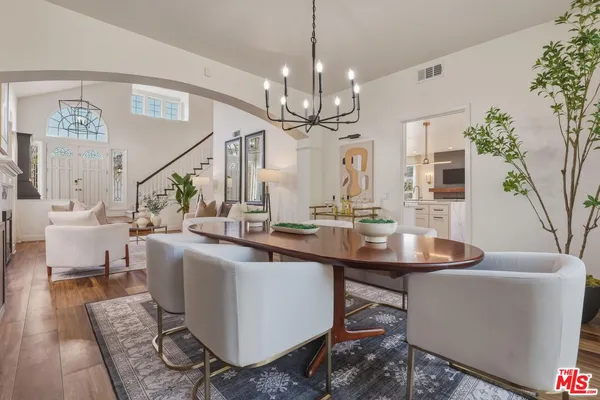 a view of a dining room with furniture and a chandelier