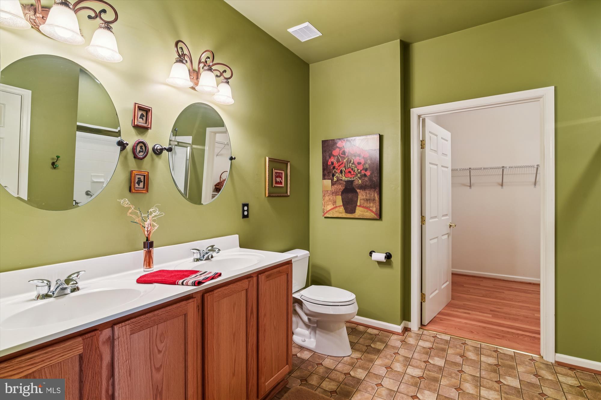 9 Brighton Street Ocean View, DE 19970 - Photo 29 of 48 a bathroom with a granite countertop toilet a sink and a mirror