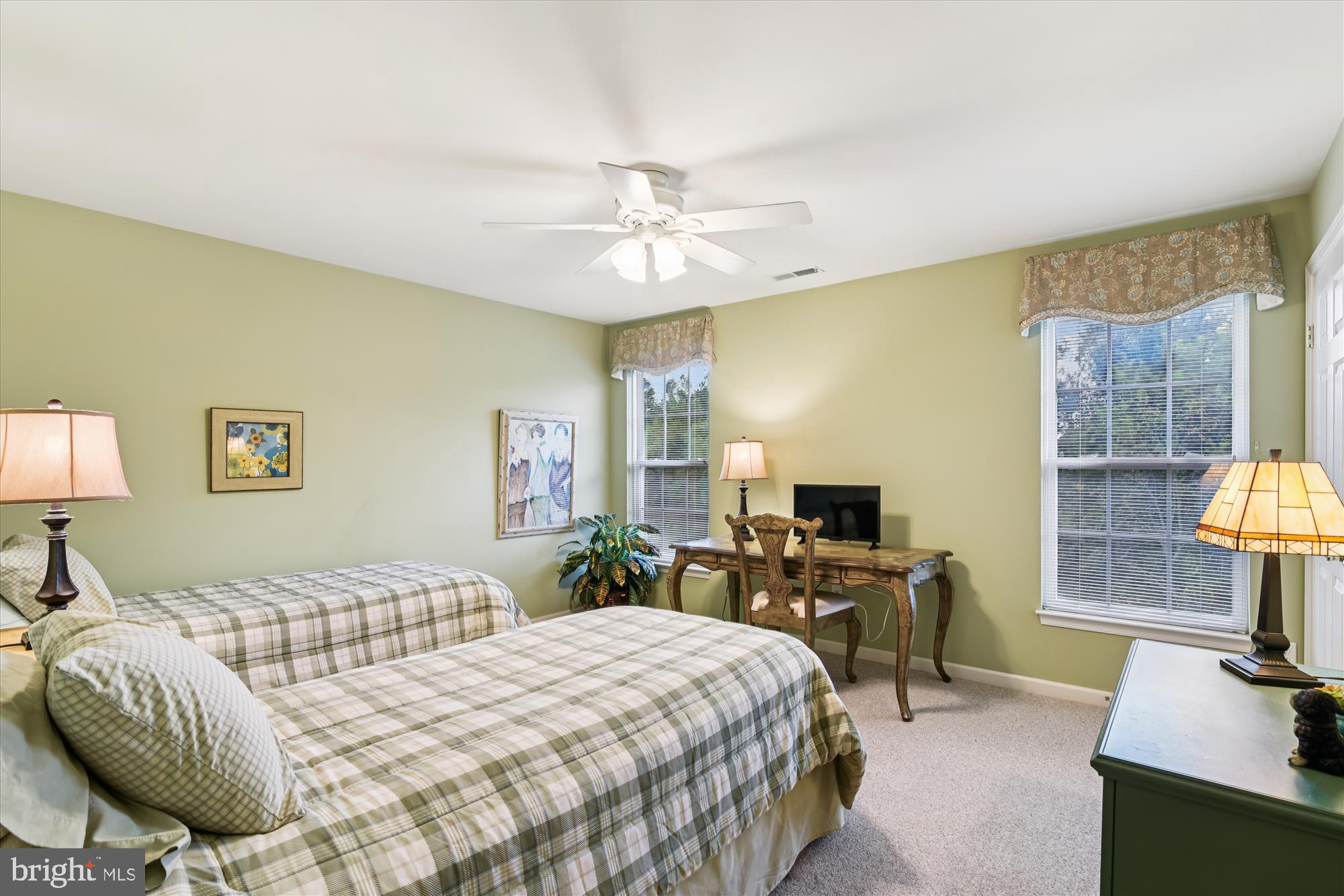 9 Brighton Street Ocean View, DE 19970 - Photo 37 of 48 a bedroom with a bed a table and large windows