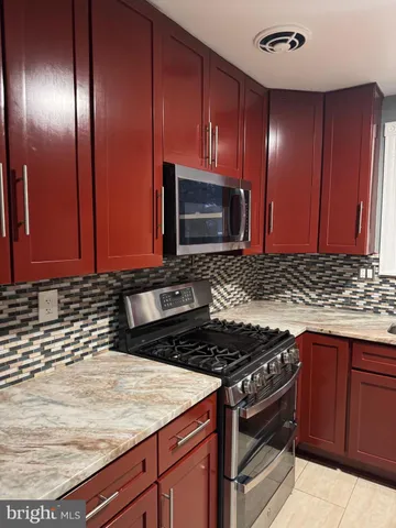 a kitchen with granite countertop stainless steel appliances and cabinets