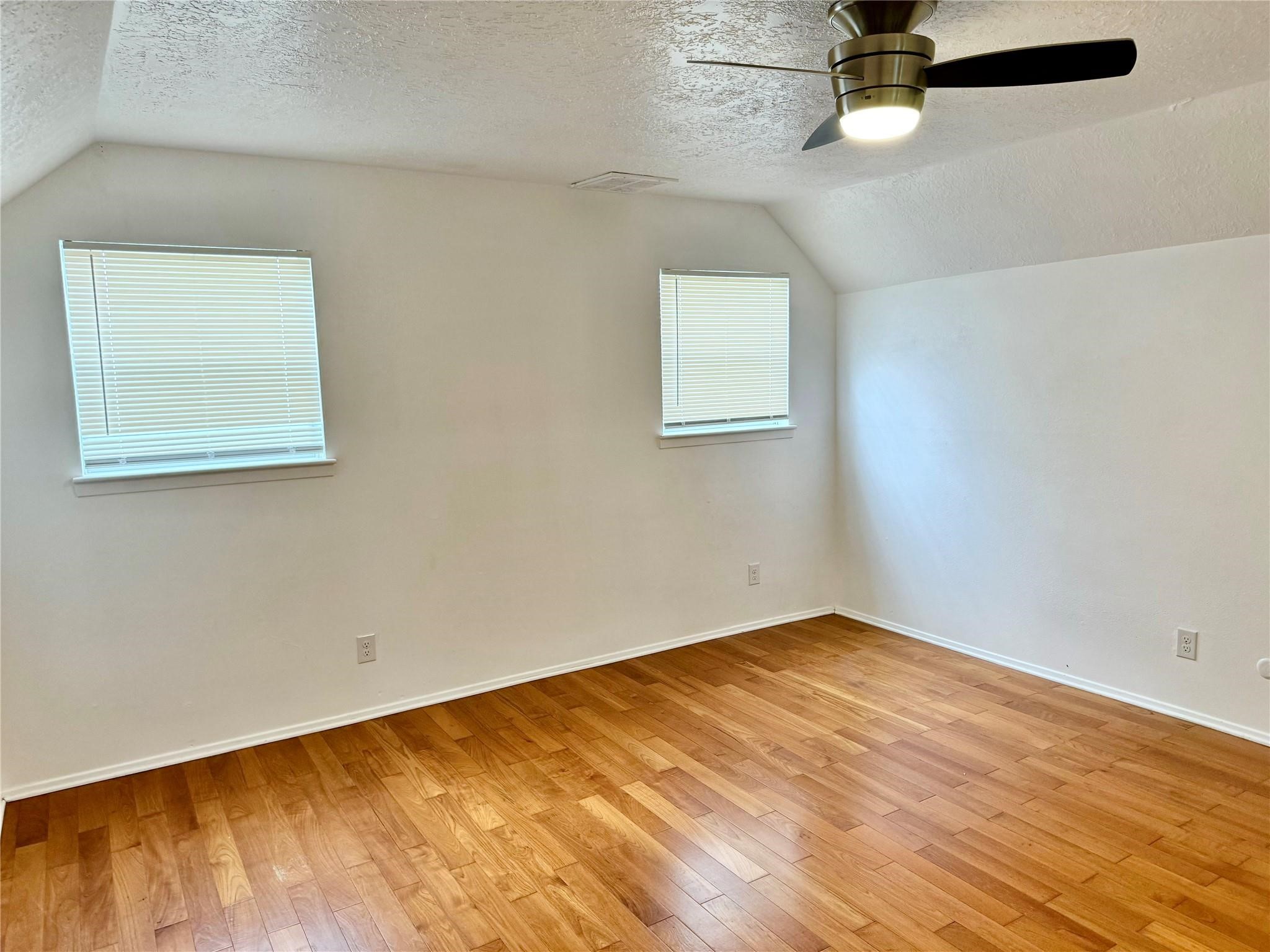7015 Pyron Way Houston, TX 77036 - Photo 10 of 12 an empty room with a window and a ceiling fan