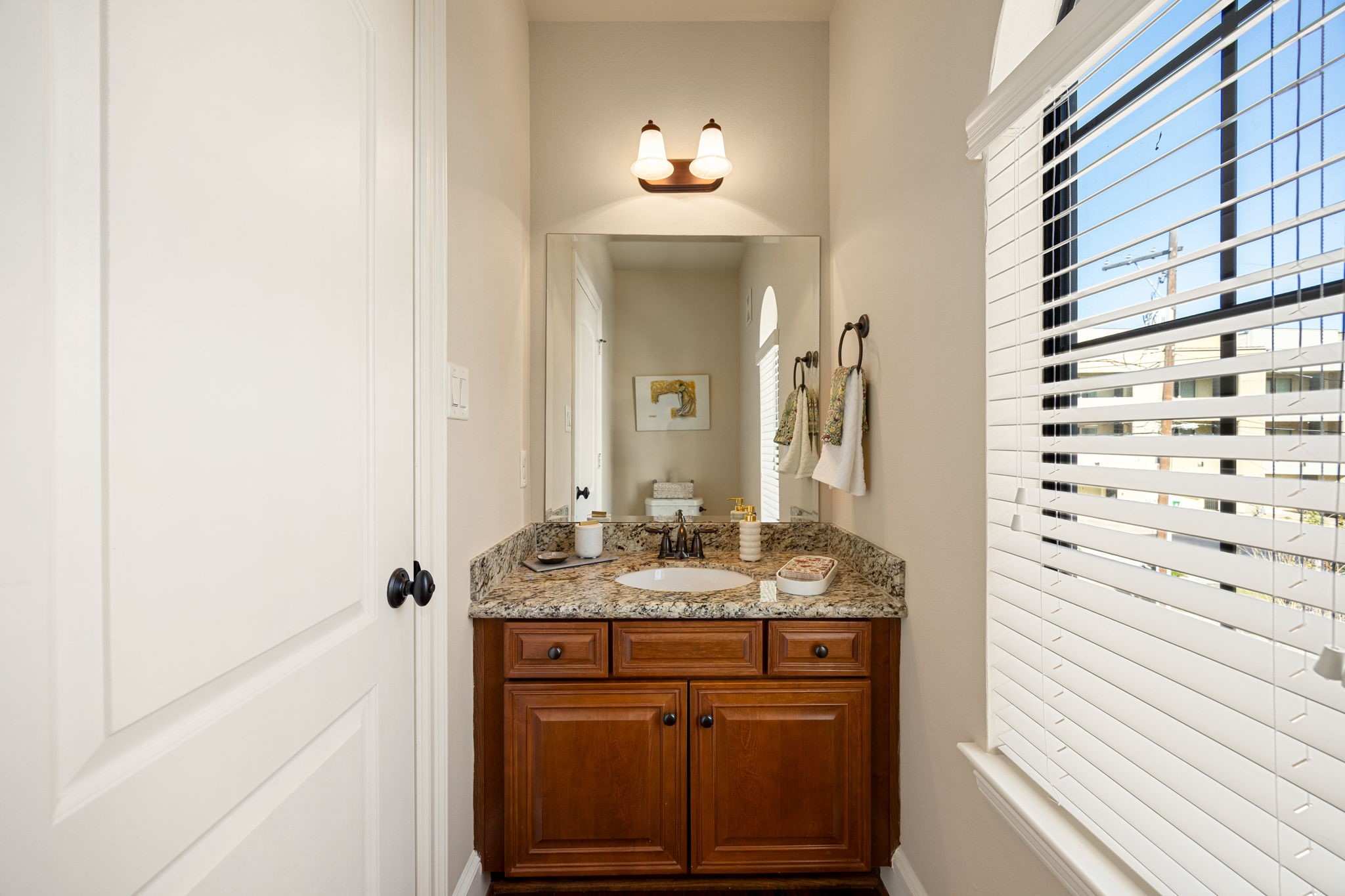 821 Lester Street Houston, TX 77007 - Photo 13 of 41 Bright and chic powder room is conveniently located by the staircase to offer privacy.