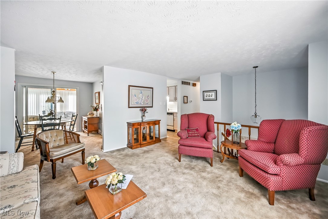 7797 Raglan Drive Northeast Warren, OH 44484 - Photo 20 of 50 Living area with carpet flooring and a textured ceiling