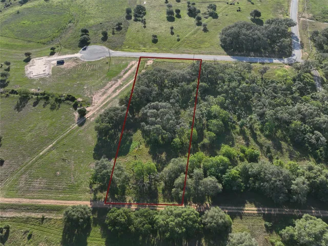an aerial view of a houses with a yard