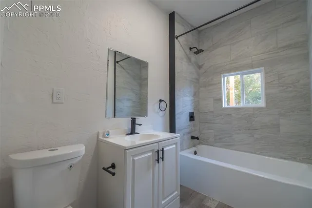 a bathroom with a sink mirror toilet and bathtub