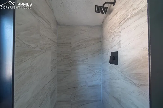 a view of an empty room and wooden floor