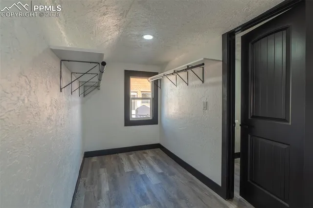 a bathroom with a granite countertop toilet a sink and a mirror