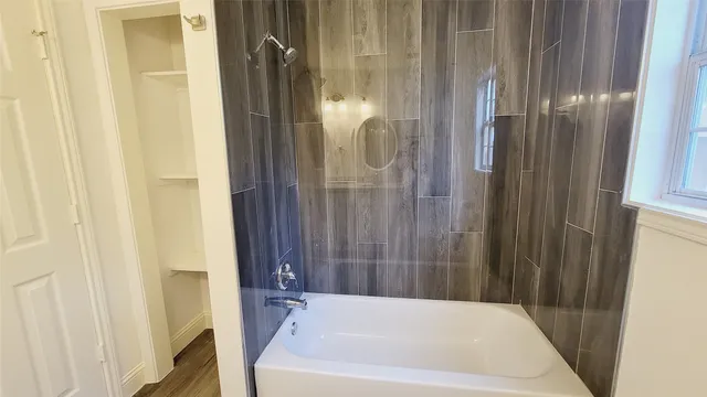 a bathroom with shower and bathtub