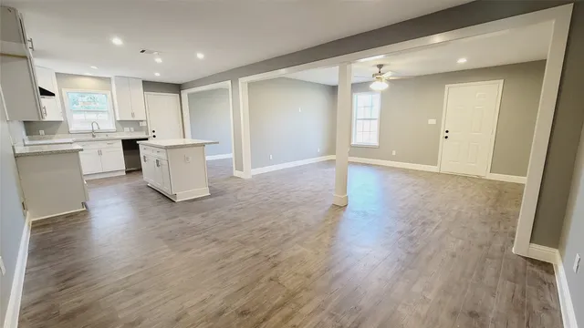 a view of kitchen with cabinets and wooden floor