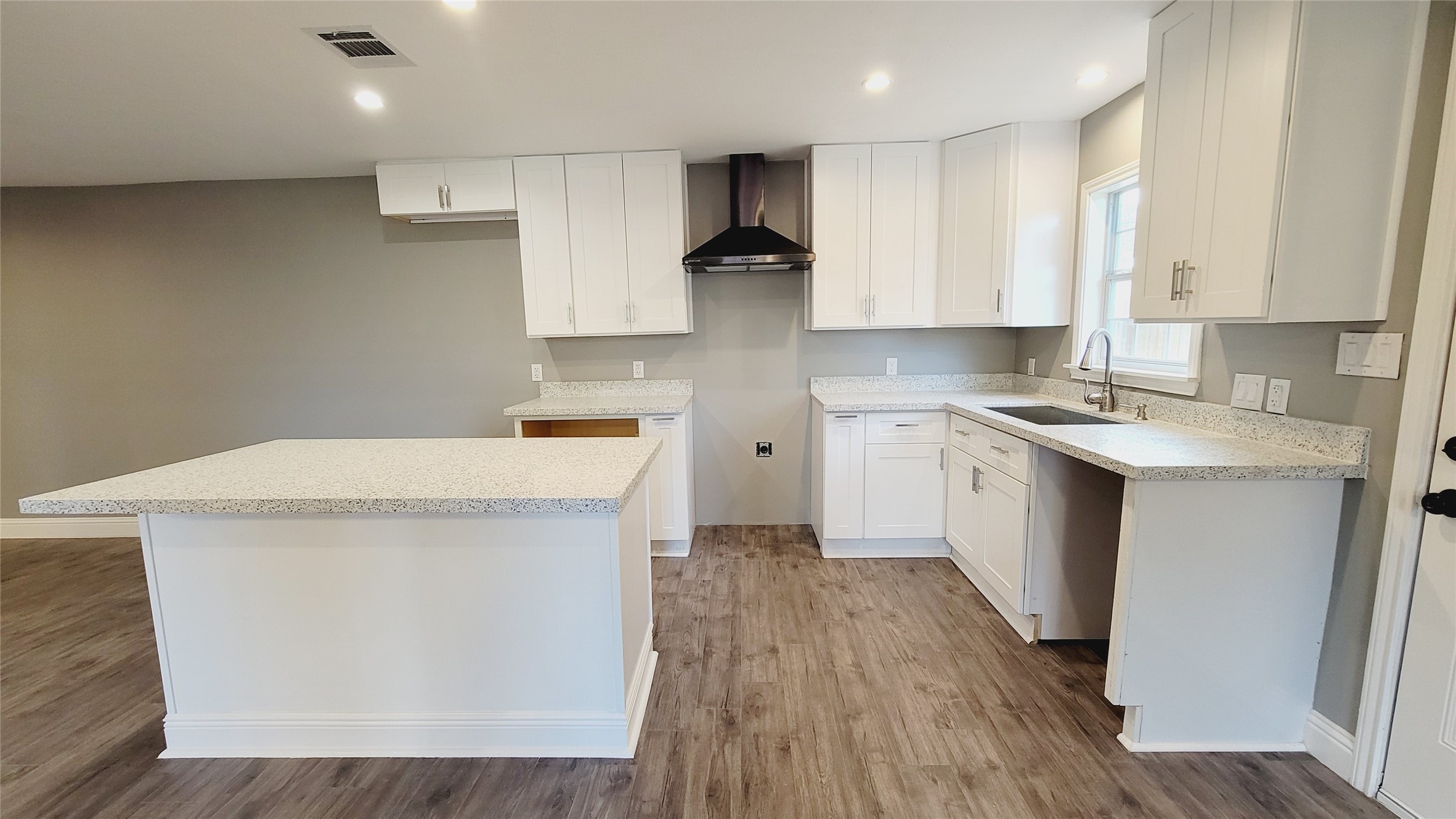 4034 Dreyfus Street Houston, TX 77021 - Photo 6 of 32 a kitchen with a sink a stove a refrigerator and white cabinets