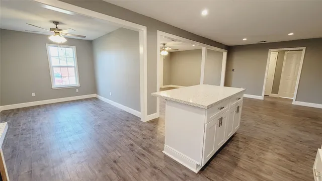 a utility room with wooden floor and window