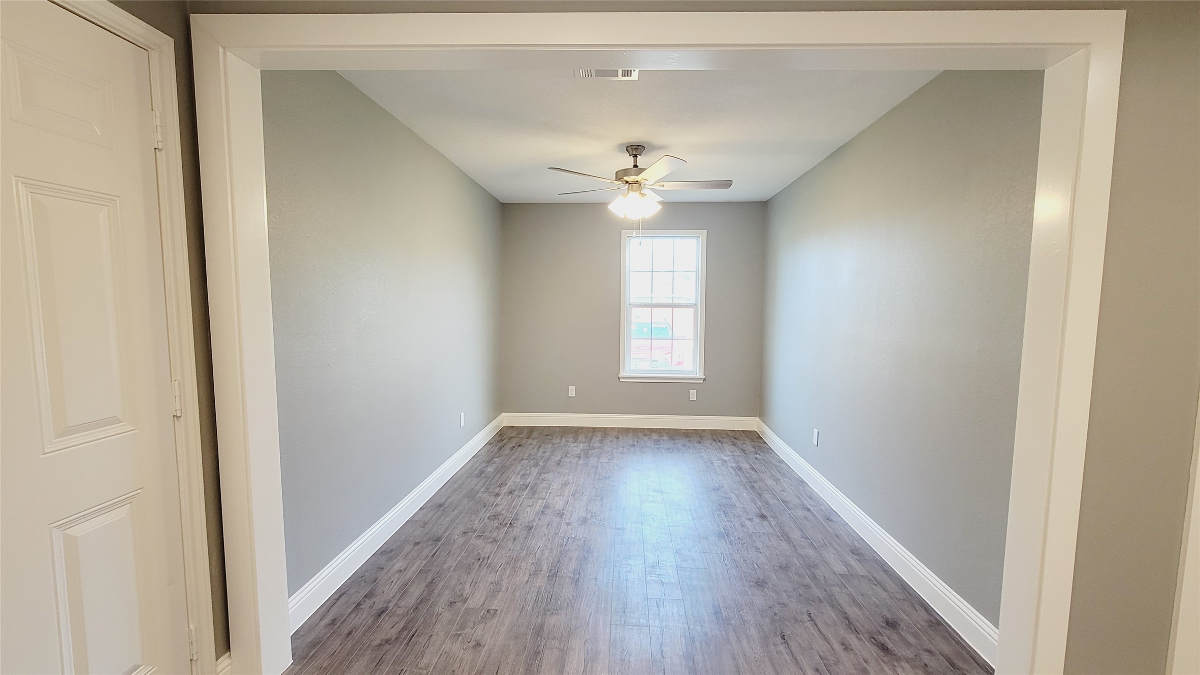 4034 Dreyfus Street Houston, TX 77021 - Photo 8 of 32 wooden floor in an empty room with a window