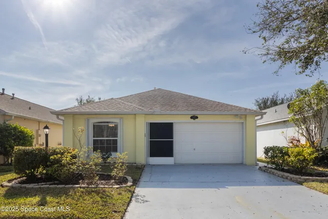 front view of house with potted plants