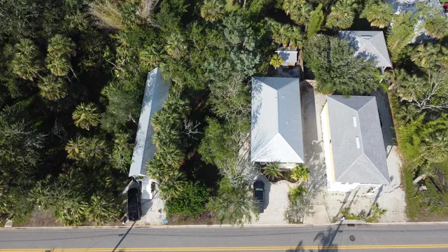 an aerial view of a house with yard
