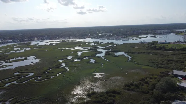 an aerial view of a houses with ocean view
