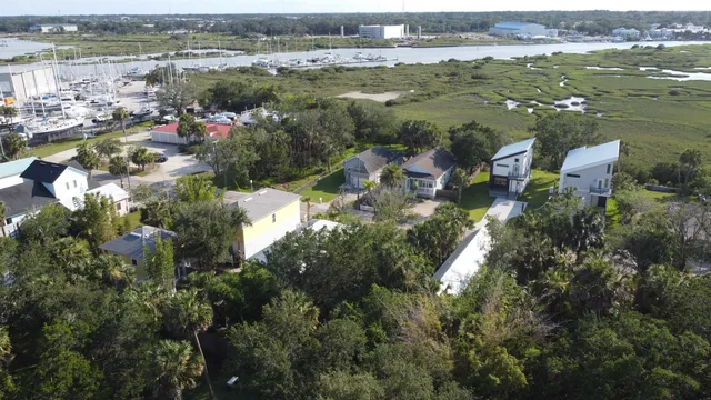 an aerial view of residential houses with outdoor space and river