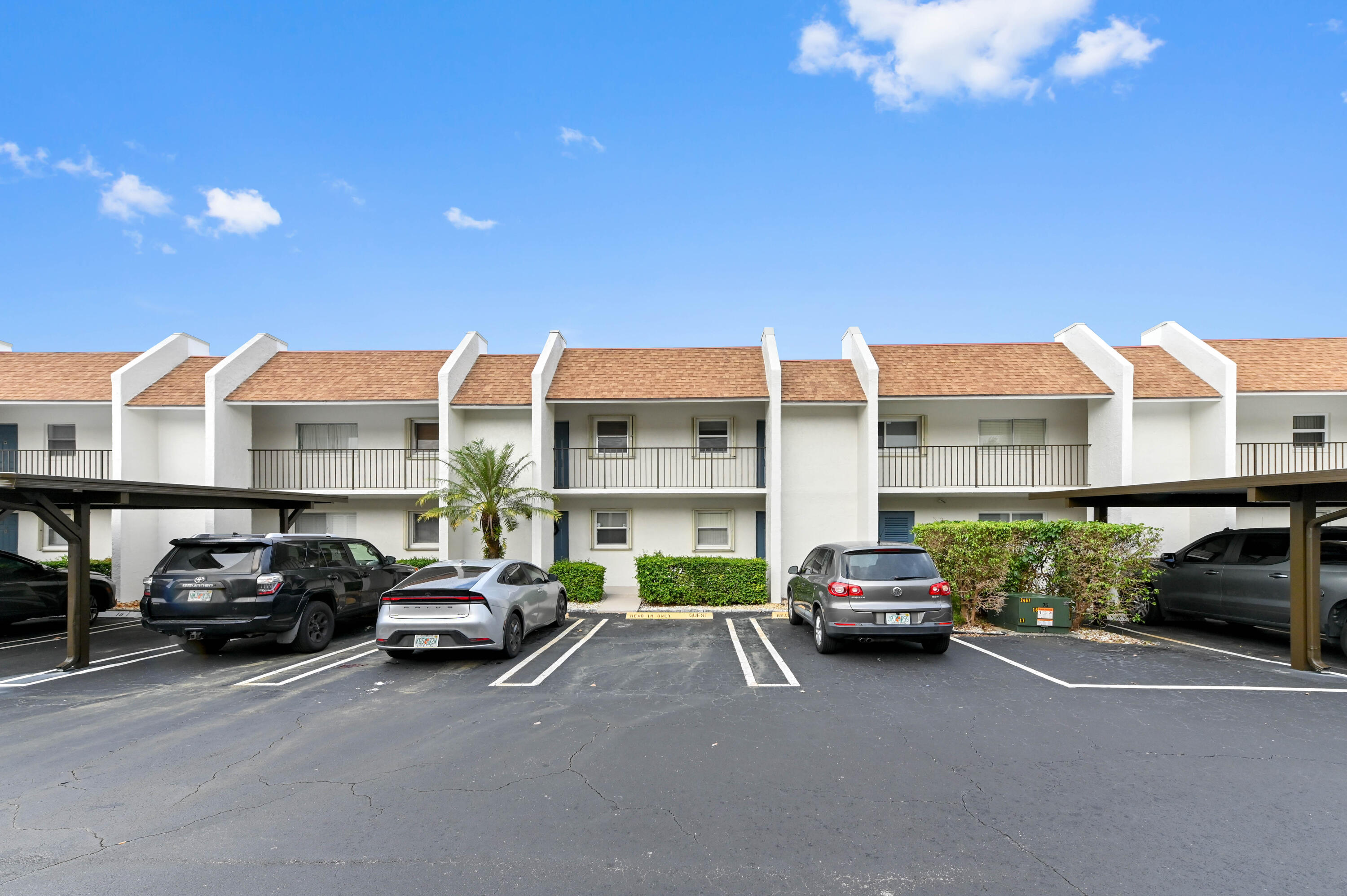 2905 Southwest 22nd Avenue, Unit 1080 Delray Beach, FL 33445 - Photo 2 of 33 a view of a car parked in front of a building