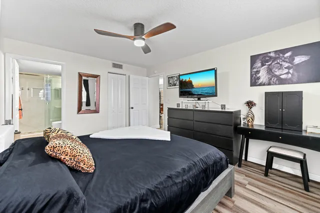 a bedroom with a bed and a flat screen tv