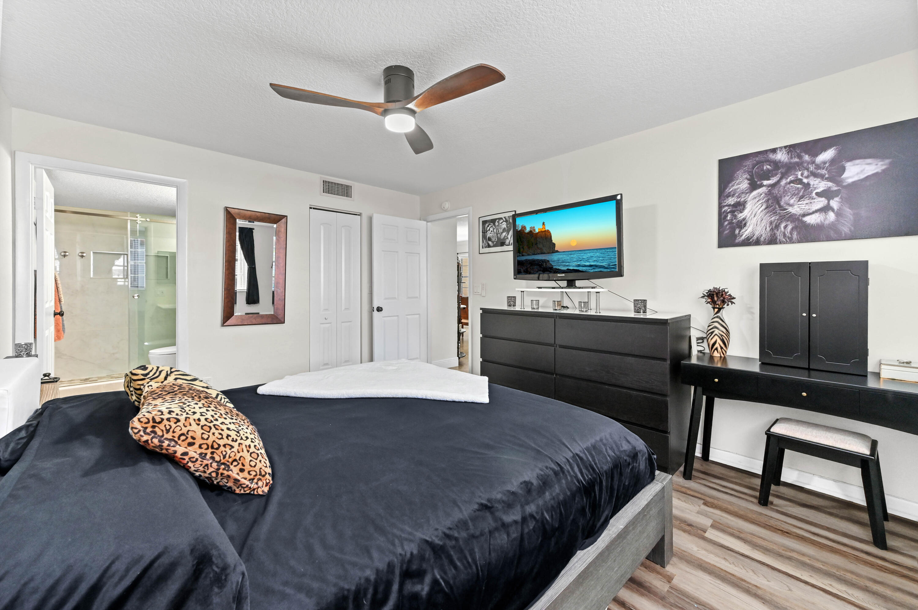 2905 Southwest 22nd Avenue, Unit 1080 Delray Beach, FL 33445 - Photo 22 of 33 a bedroom with a bed and a flat screen tv