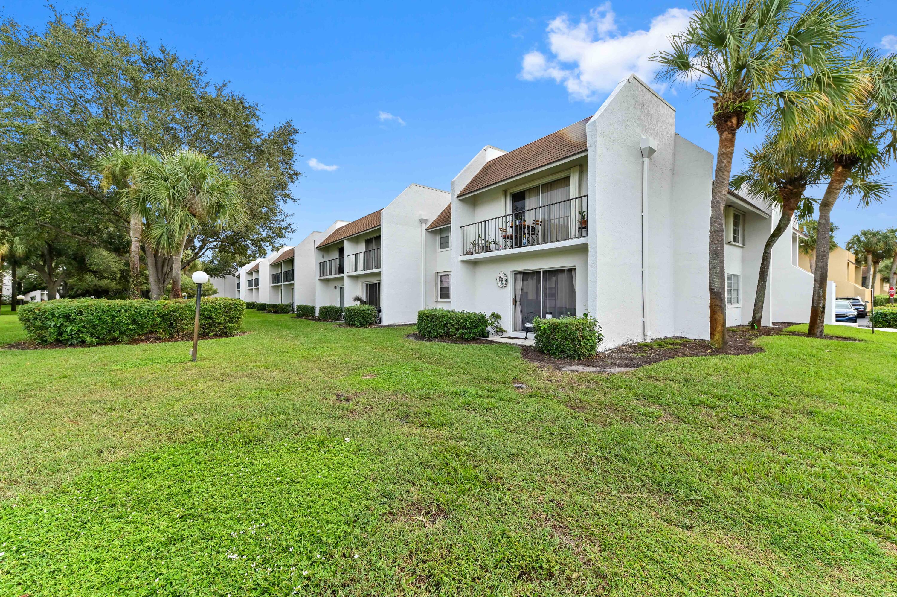 2905 Southwest 22nd Avenue, Unit 1080 Delray Beach, FL 33445 - Photo 25 of 33 a view of a house with backyard and trees