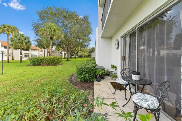 a backyard of a house with table and chairs