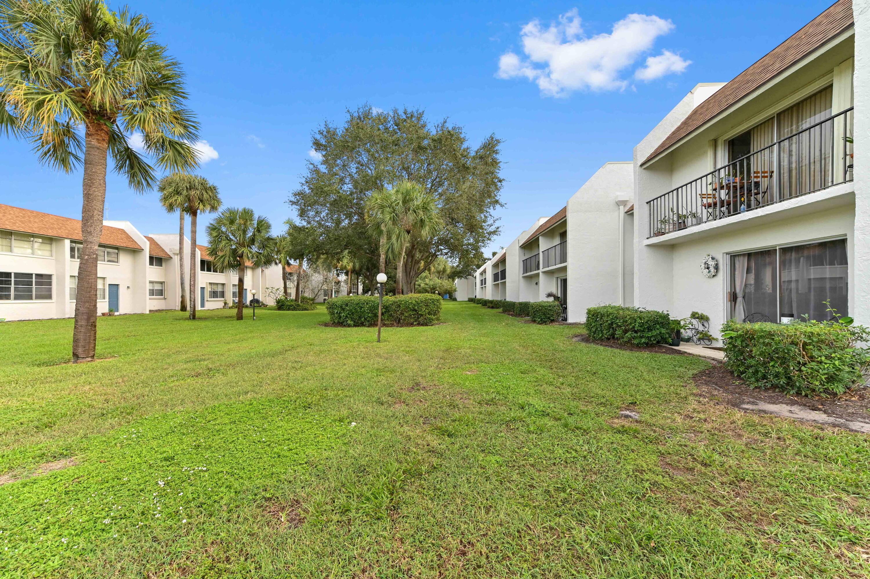 2905 Southwest 22nd Avenue, Unit 1080 Delray Beach, FL 33445 - Photo 28 of 33 a view of a house with a backyard