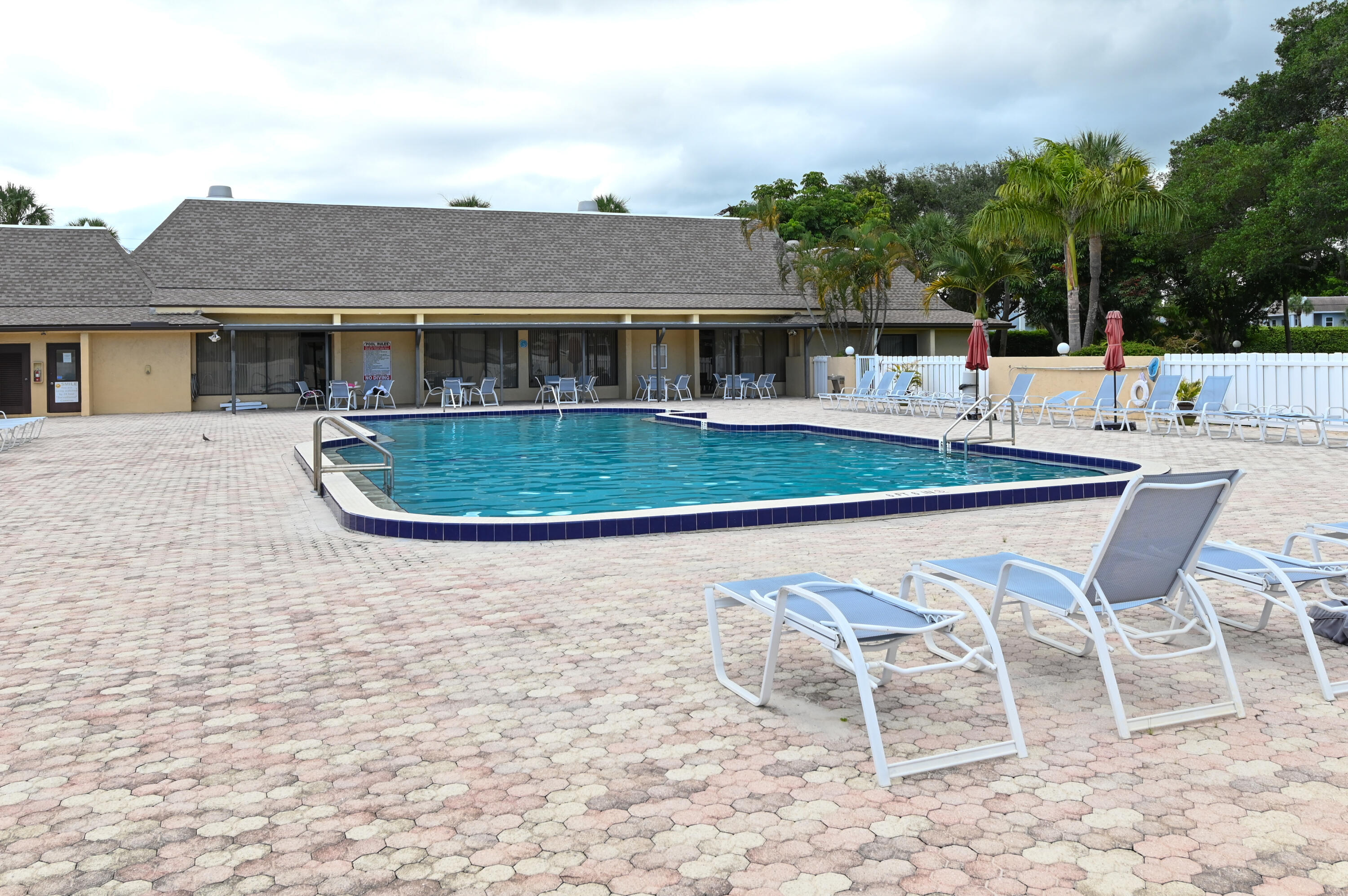 2905 Southwest 22nd Avenue, Unit 1080 Delray Beach, FL 33445 - Photo 29 of 33 a view of a house with a yard and sitting area
