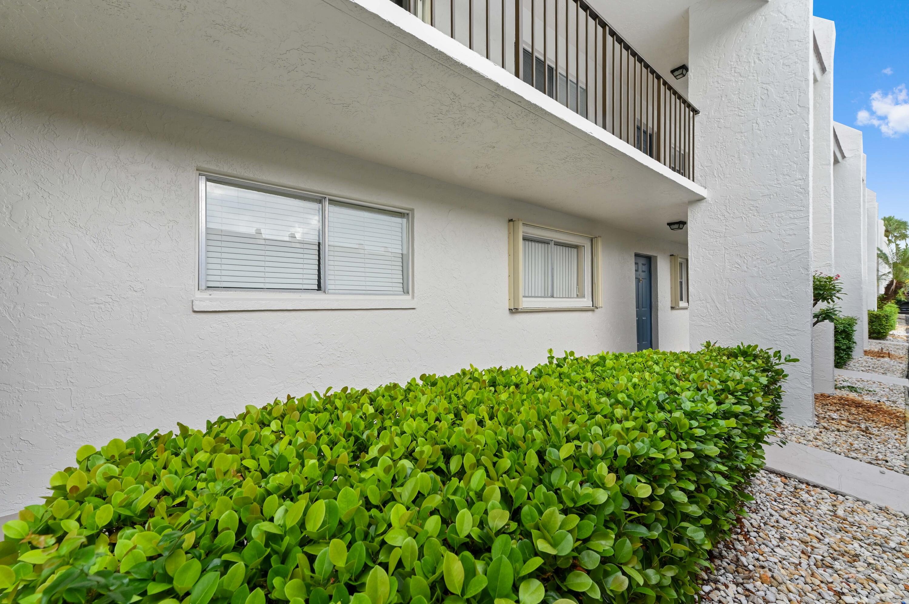2905 Southwest 22nd Avenue, Unit 1080 Delray Beach, FL 33445 - Photo 3 of 33 a view of a house with a flower garden