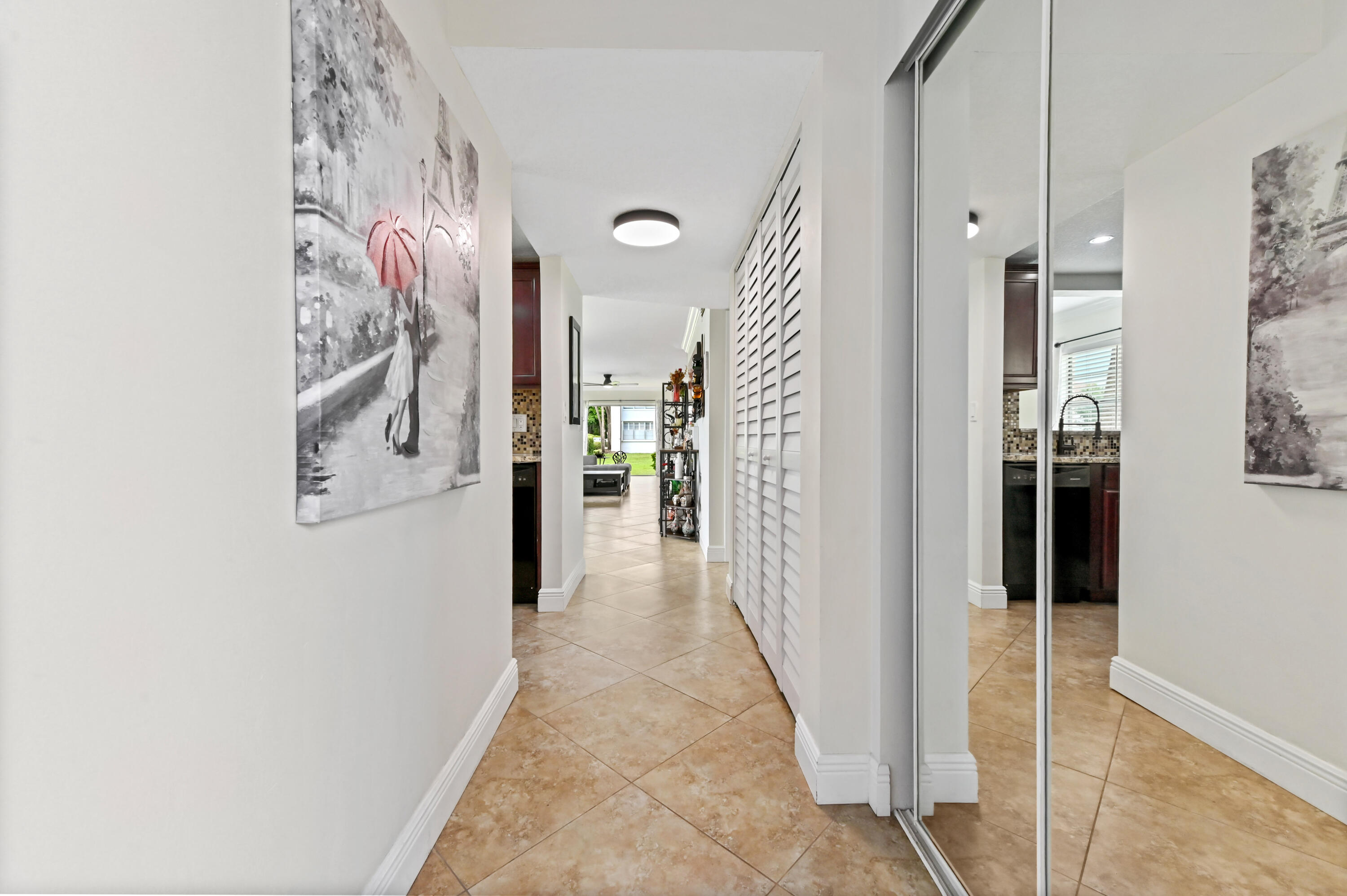 2905 Southwest 22nd Avenue, Unit 1080 Delray Beach, FL 33445 - Photo 6 of 33 a view of a hallway with a dining area