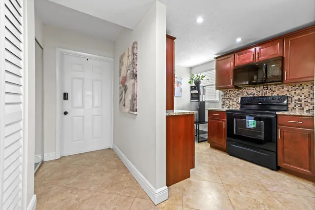 a kitchen with stainless steel appliances granite countertop a stove and a refrigerator