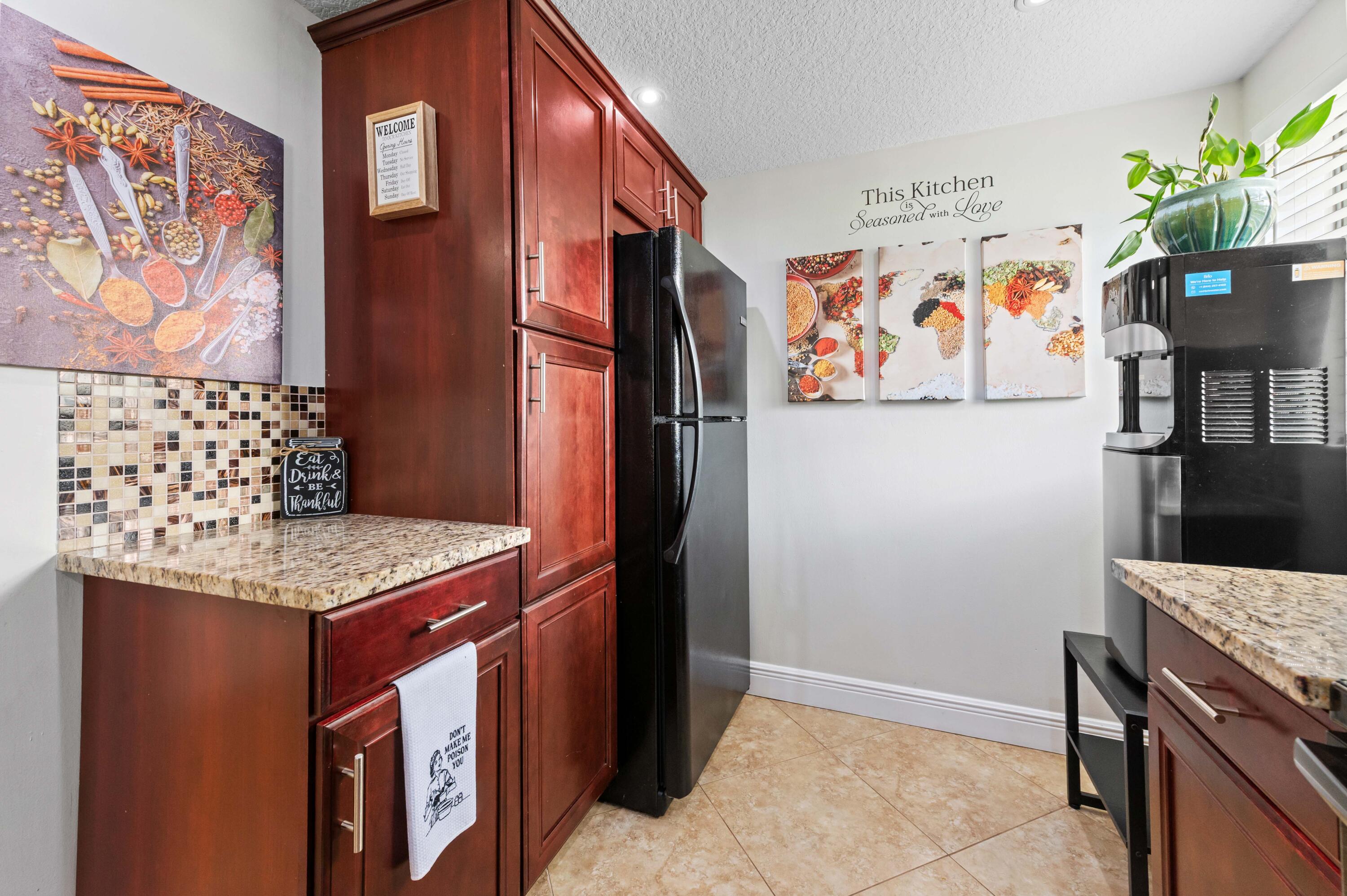 2905 Southwest 22nd Avenue, Unit 1080 Delray Beach, FL 33445 - Photo 10 of 33 a room with cabinets and painting on the wall