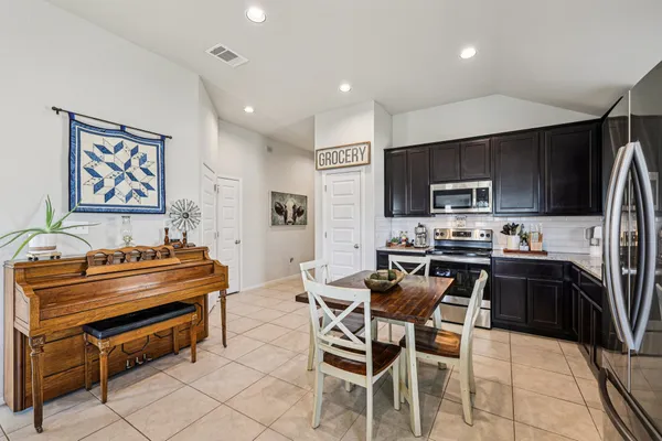 a large kitchen with a table and chairs