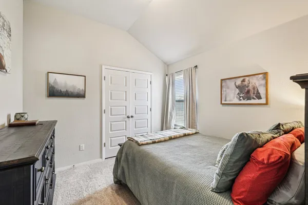 a bedroom with a bed and a table