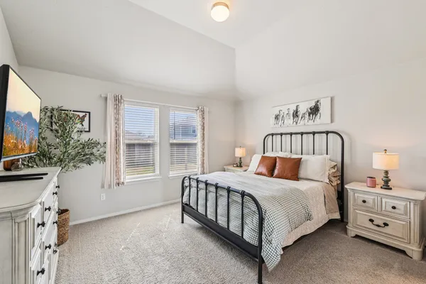 a bedroom with a bed and a night stand