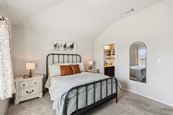 a bedroom with a bed and a dresser