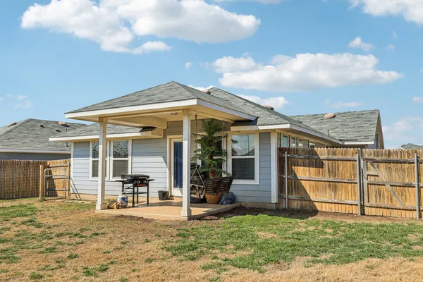 a view of a house with a yard and sitting area