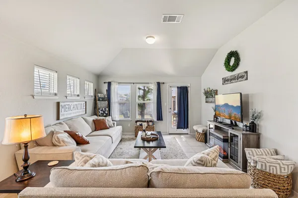 a living room with furniture and a flat screen tv