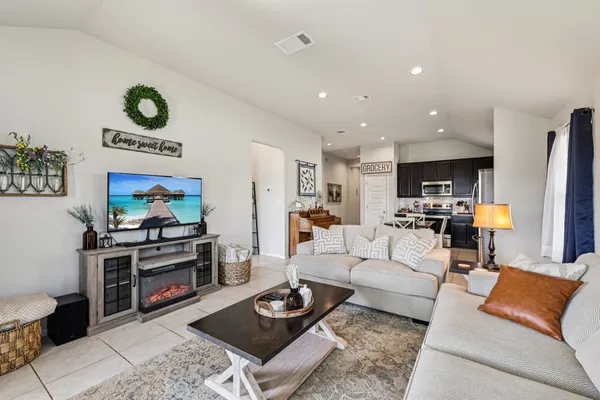 a living room with furniture and a flat screen tv
