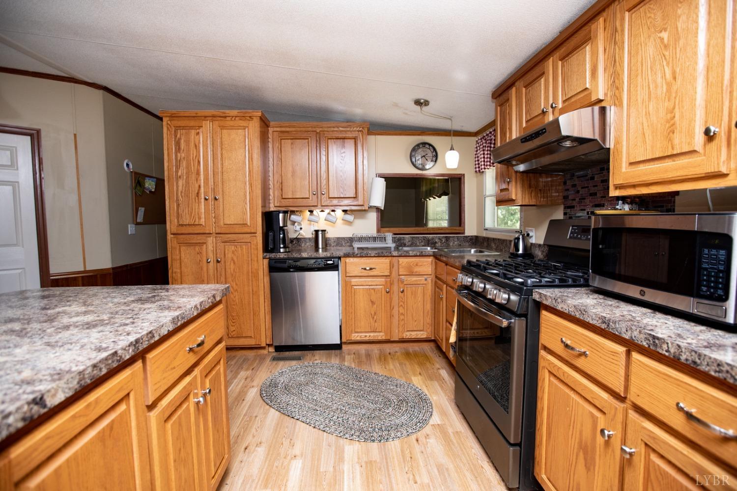 484 Old Oak Road Prospect, VA 23960 - Photo 5 of 20 a kitchen with stainless steel appliances granite countertop a stove a sink and a microwave