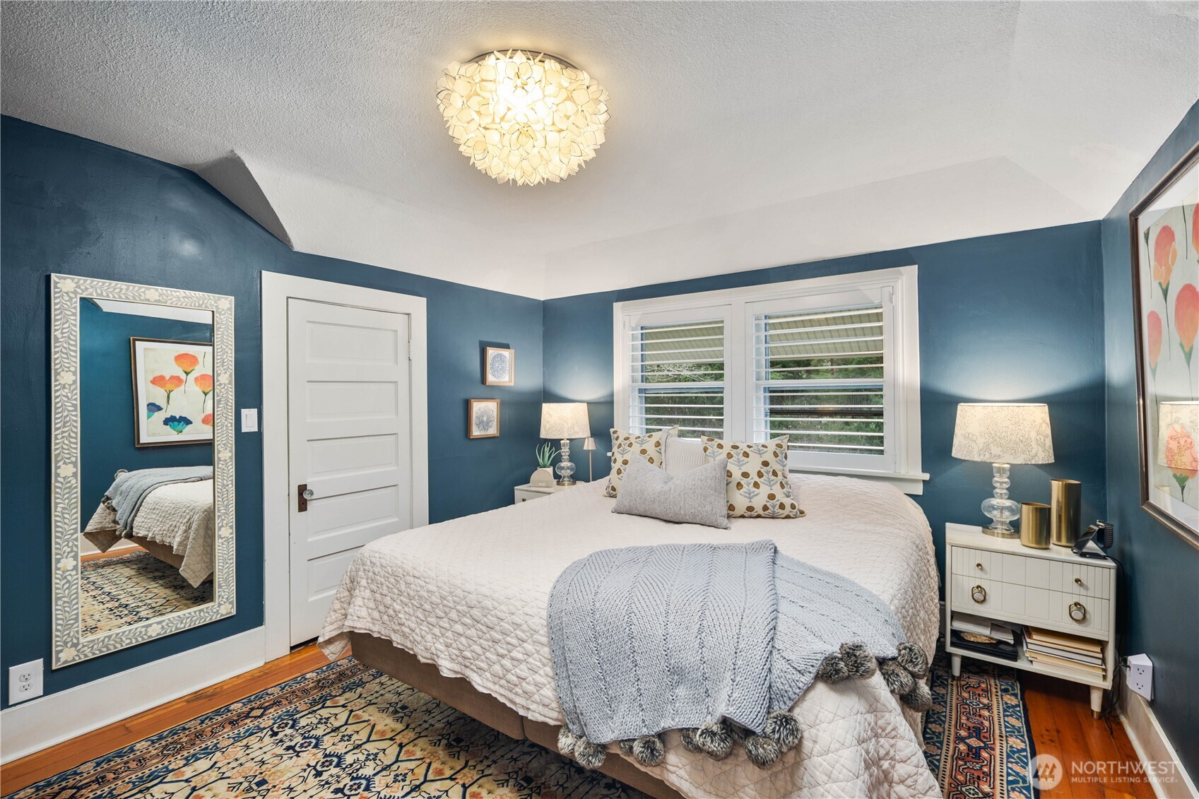 641 Northwest 175th Street Shoreline, WA 98177 - Photo 17 of 40 a bedroom with a bed and a chandelier